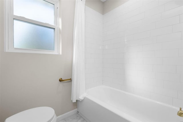 bathroom with toilet and shower / tub combo with curtain