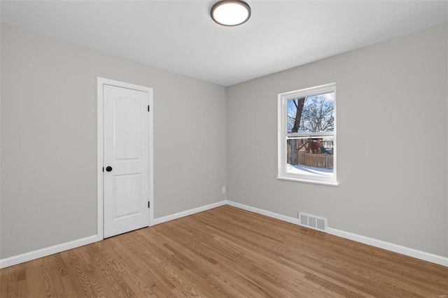 spare room with light wood-type flooring