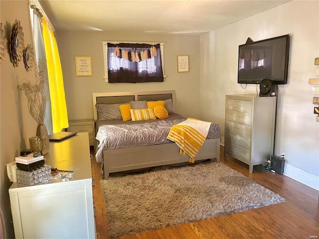 bedroom with hardwood / wood-style flooring