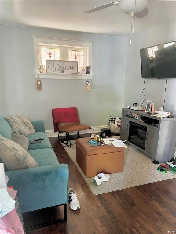 living room featuring ceiling fan and hardwood / wood-style floors