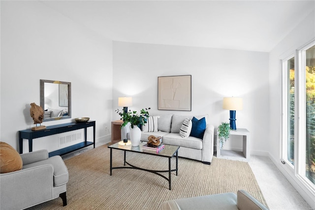 carpeted living room featuring plenty of natural light