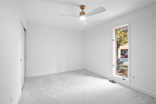 unfurnished room featuring ceiling fan and light colored carpet