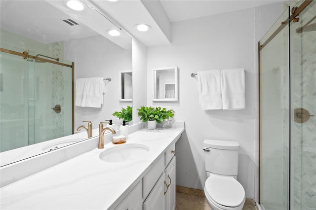 bathroom with toilet, tile patterned flooring, vanity, and walk in shower