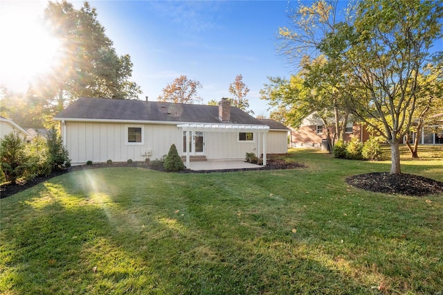 back of house with a patio, a yard, and a pergola