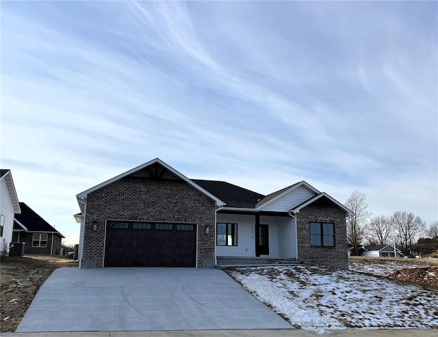 view of front of home featuring a garage and central AC