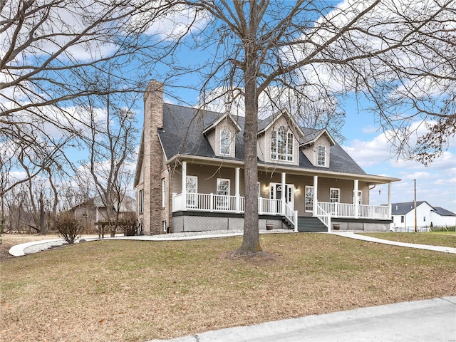 new england style home featuring a front yard and covered porch