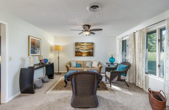 carpeted living room with ceiling fan