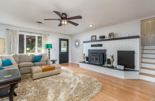 living room featuring ceiling fan and wood-type flooring