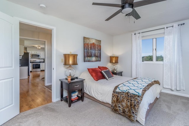 carpeted bedroom with stainless steel fridge and ceiling fan