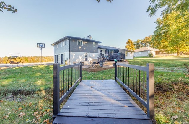 back of property featuring a lawn and a wooden deck