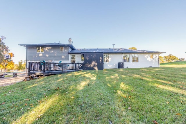 rear view of property featuring a yard, a wooden deck, and central air condition unit