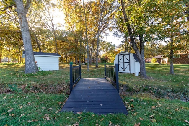 view of community with a lawn and a storage shed