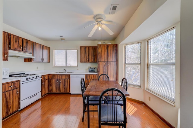 kitchen with ceiling fan, sink, white appliances, and light hardwood / wood-style flooring