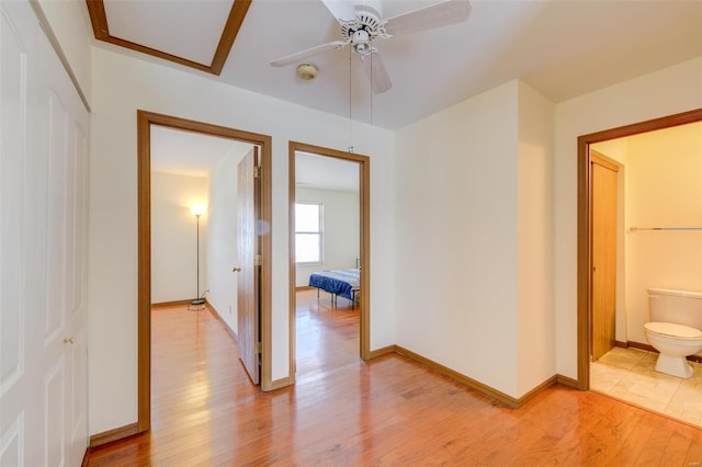 hallway with light hardwood / wood-style floors