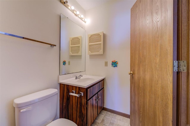 bathroom featuring toilet and vanity