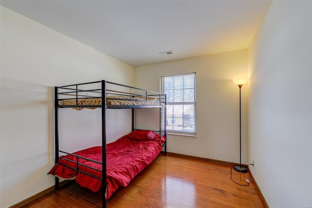 bedroom with hardwood / wood-style flooring