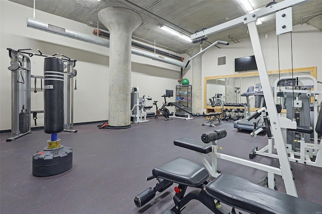 exercise room with a towering ceiling