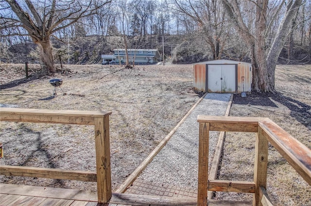 view of yard with a storage shed and an outbuilding