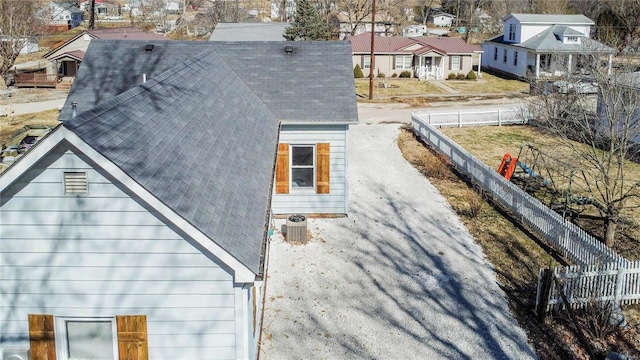 exterior space with driveway, a residential view, and fence