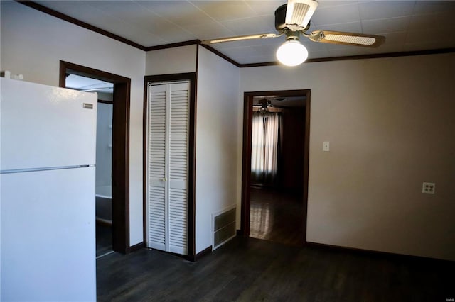 interior space featuring baseboards, visible vents, a ceiling fan, dark wood-style flooring, and crown molding