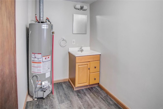 utility room with water heater and a sink