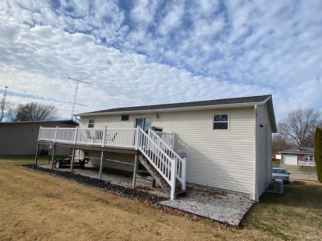 rear view of property with a lawn and a wooden deck