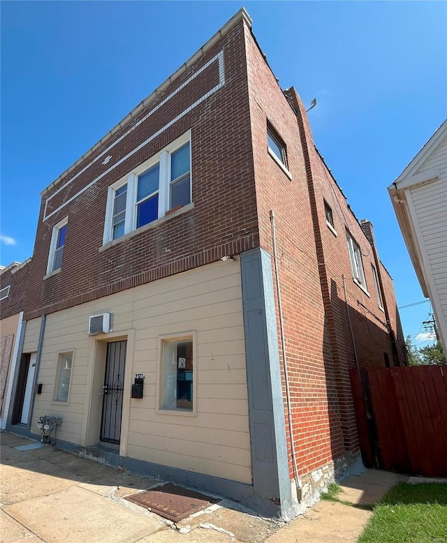 view of front of property with a wall mounted air conditioner