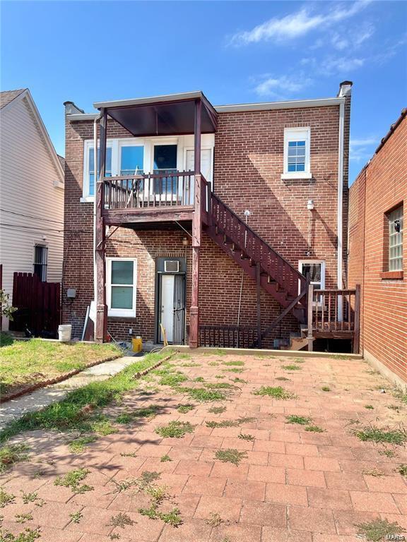 back of property featuring a balcony