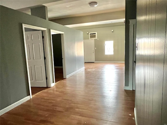 corridor with hardwood / wood-style flooring and wooden walls