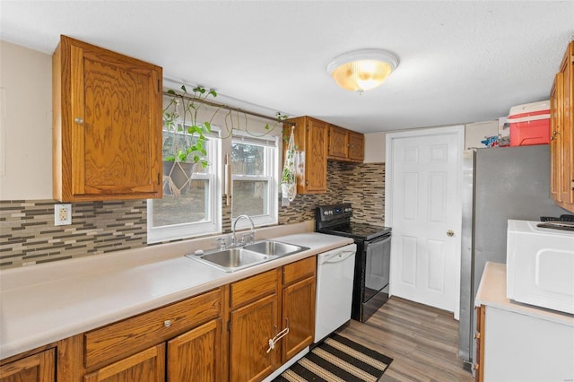 kitchen with sink, white appliances, decorative backsplash, and dark hardwood / wood-style floors