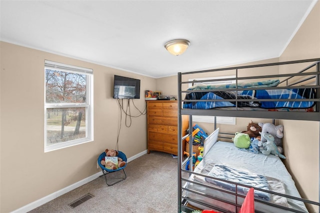 bedroom featuring ornamental molding and carpet flooring