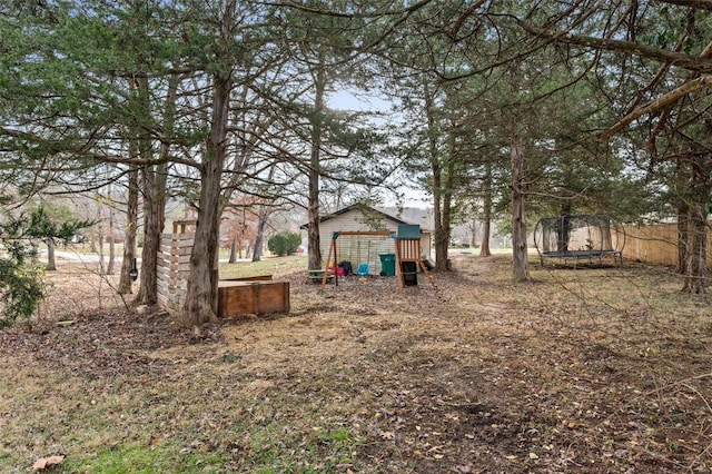 view of yard featuring a playground and a trampoline