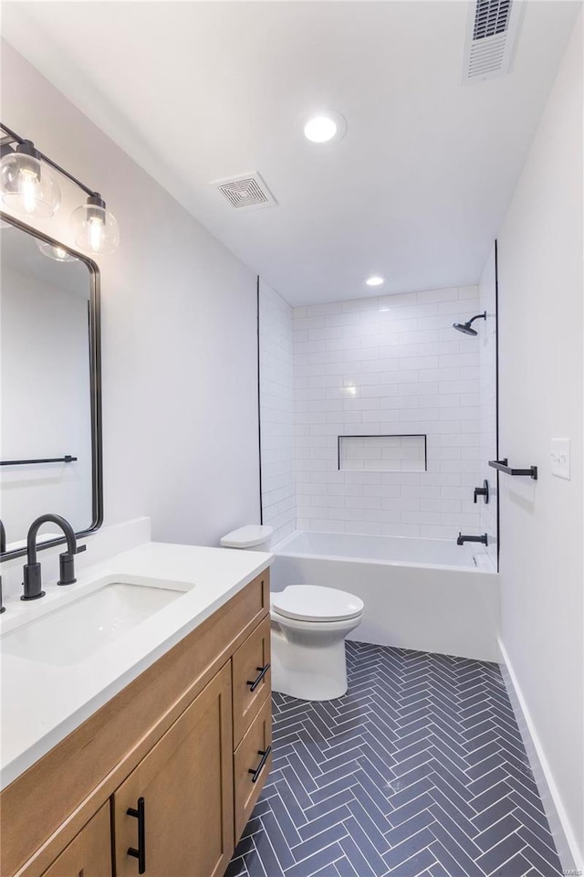 full bathroom with tiled shower / bath combo, vanity, and toilet