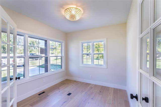 unfurnished room with light wood-type flooring