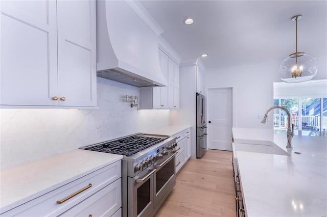 kitchen featuring premium range hood, high quality appliances, and white cabinets