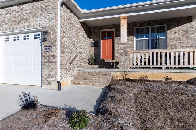 doorway to property featuring a garage and covered porch