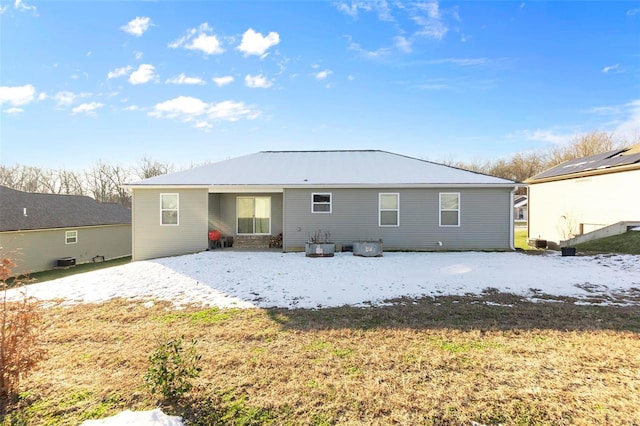 rear view of house featuring a yard