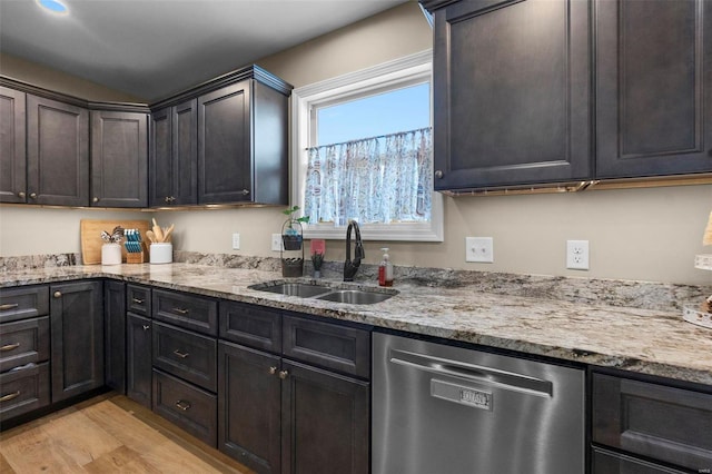 kitchen with dishwasher, sink, light wood-type flooring, light stone counters, and dark brown cabinets