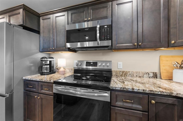 kitchen featuring stainless steel appliances and dark brown cabinetry