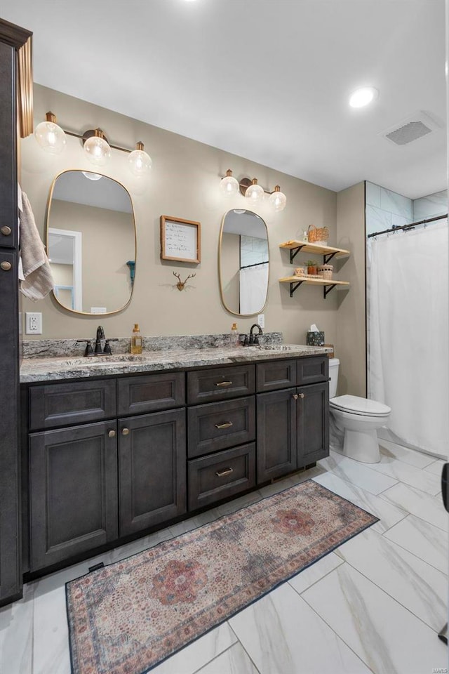 bathroom with toilet, vanity, and a shower with shower curtain