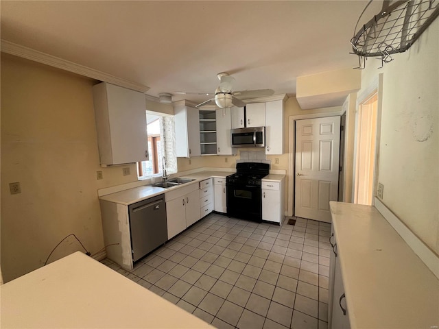 kitchen featuring sink, light tile patterned floors, black appliances, and white cabinets