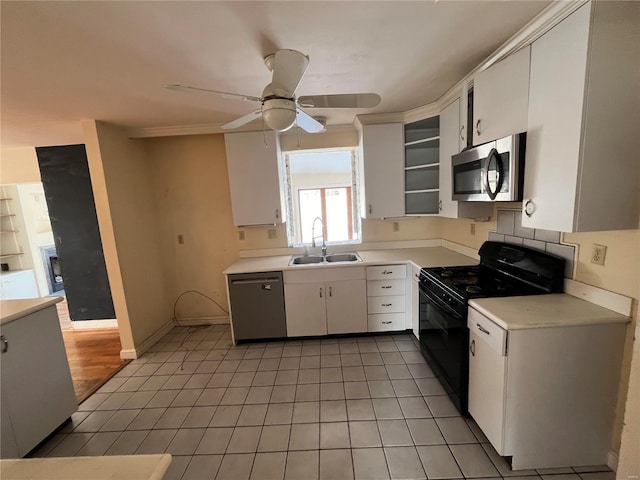 kitchen with black gas range oven, white cabinetry, dishwasher, sink, and light tile patterned floors