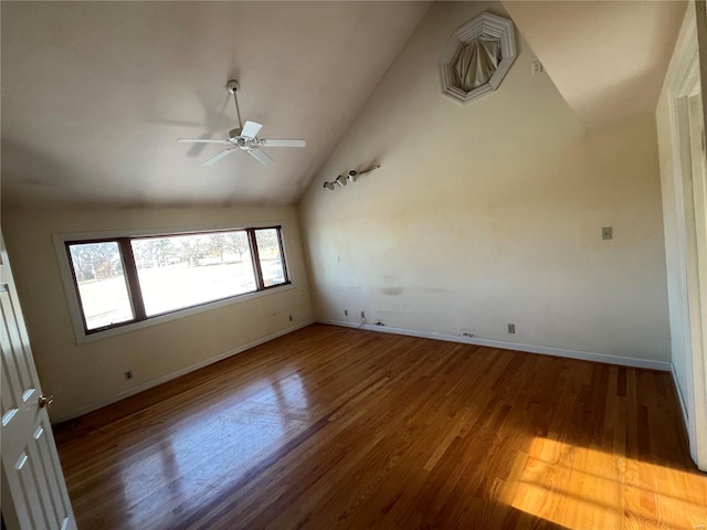 empty room featuring wood-type flooring, ceiling fan, and high vaulted ceiling