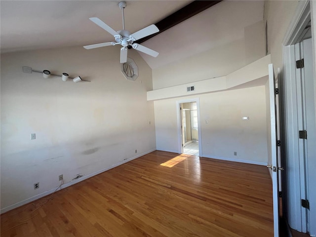 empty room with ceiling fan, high vaulted ceiling, and hardwood / wood-style floors