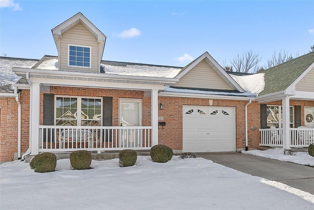 view of front of home featuring a porch and a garage