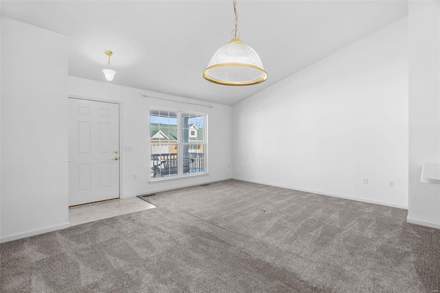 carpeted empty room with lofted ceiling