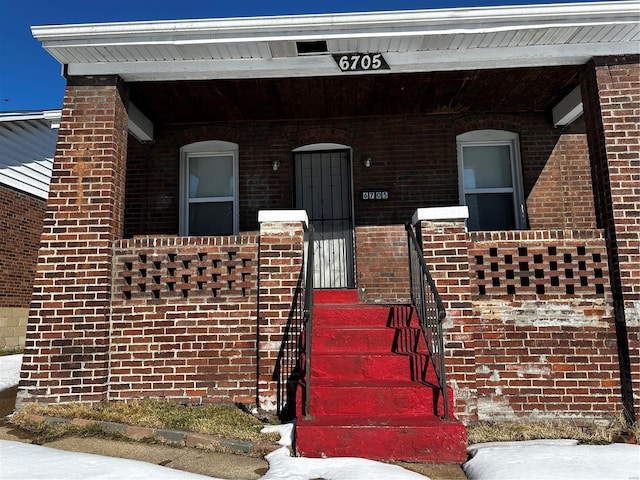 view of exterior entry with a porch