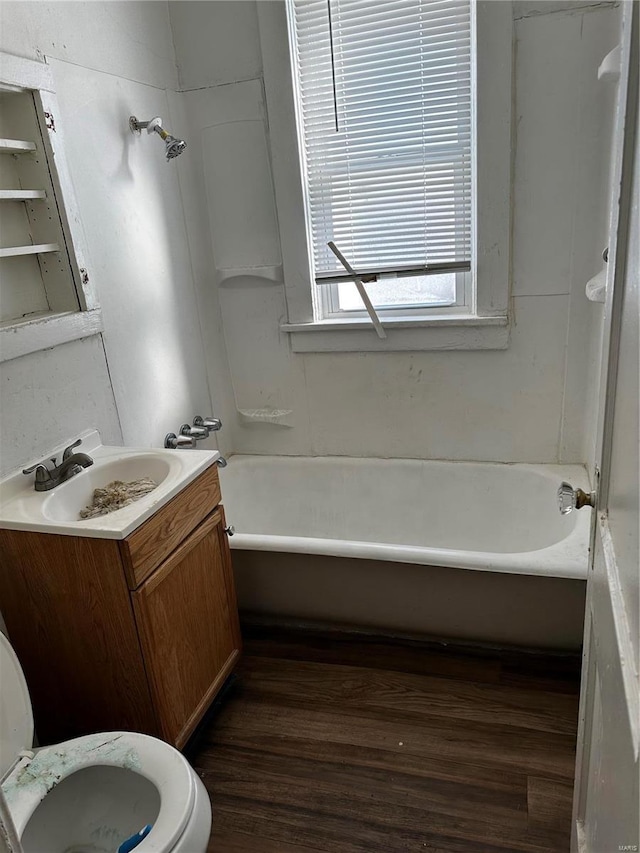 full bathroom with toilet, hardwood / wood-style flooring,  shower combination, and vanity