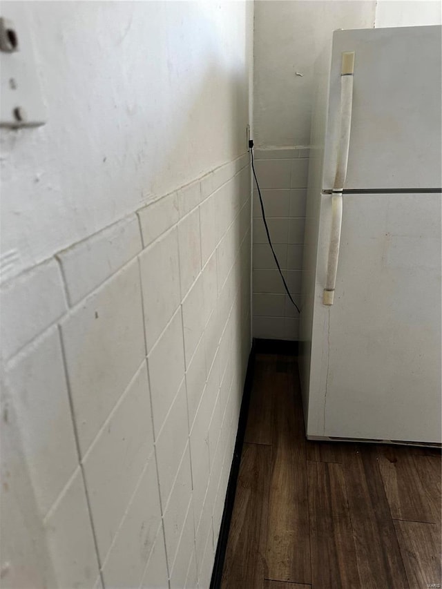 interior details with hardwood / wood-style floors and white fridge