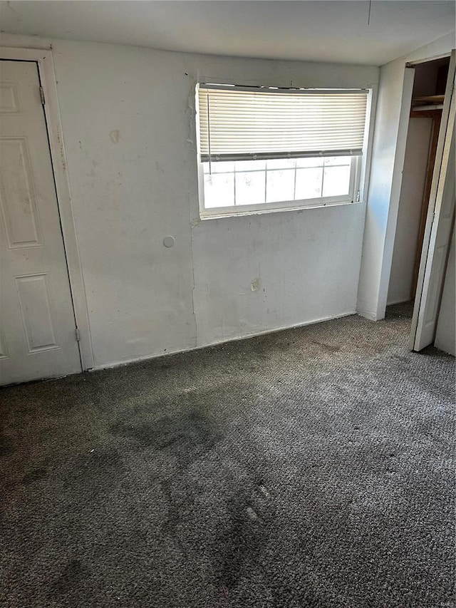 unfurnished bedroom featuring dark colored carpet